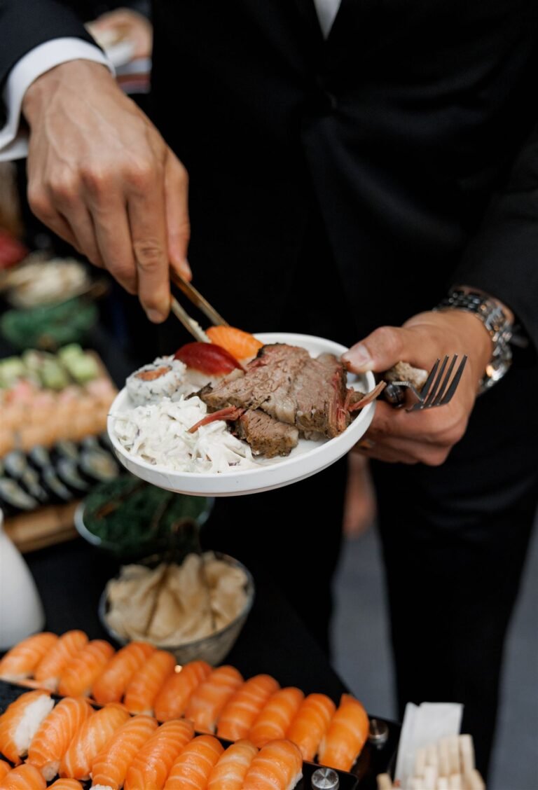 Guest serves himself from a sushi and carving station during cocktail hour