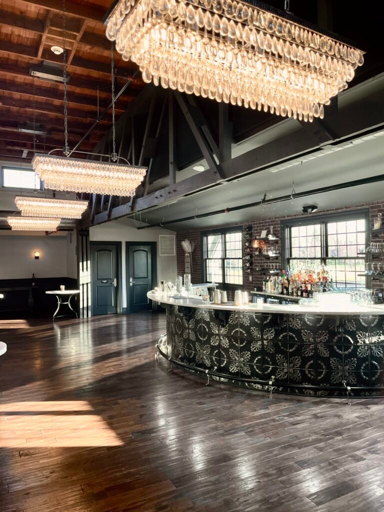 Park Loft's curved bar with crystal chandeliers and polished hardwood floors